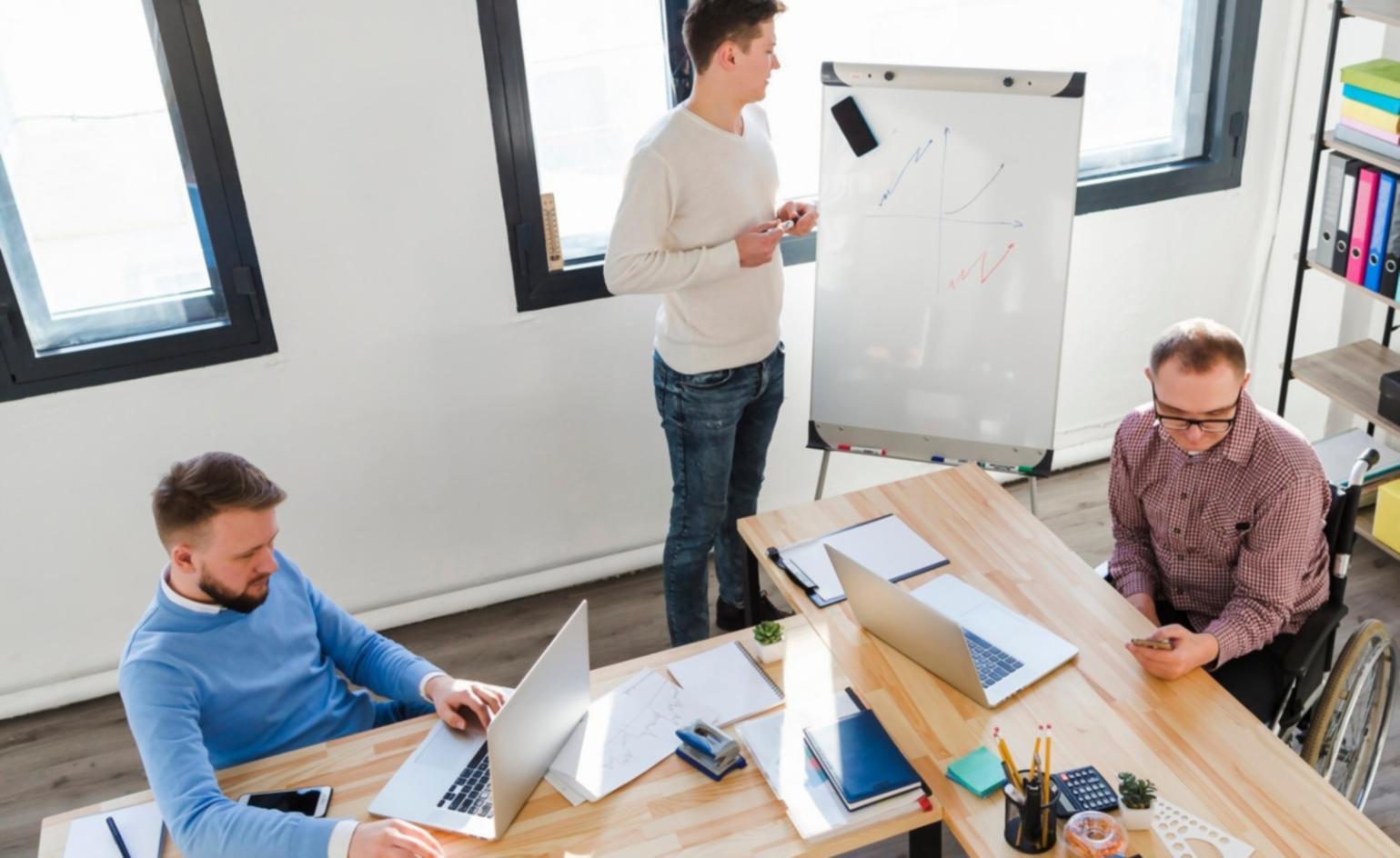 Instructor reviewing financial presentation materials with training group